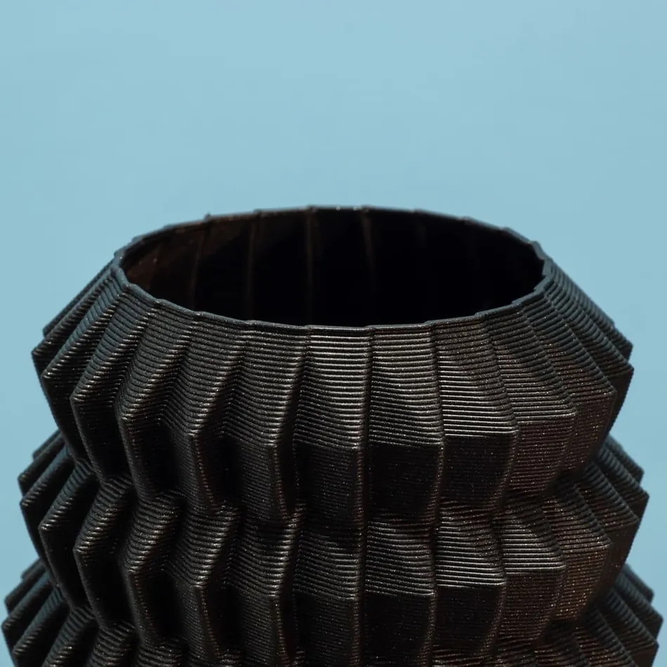 3D printer printing a black object